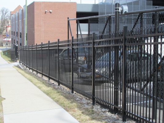 black aluminum fencing along a side walk