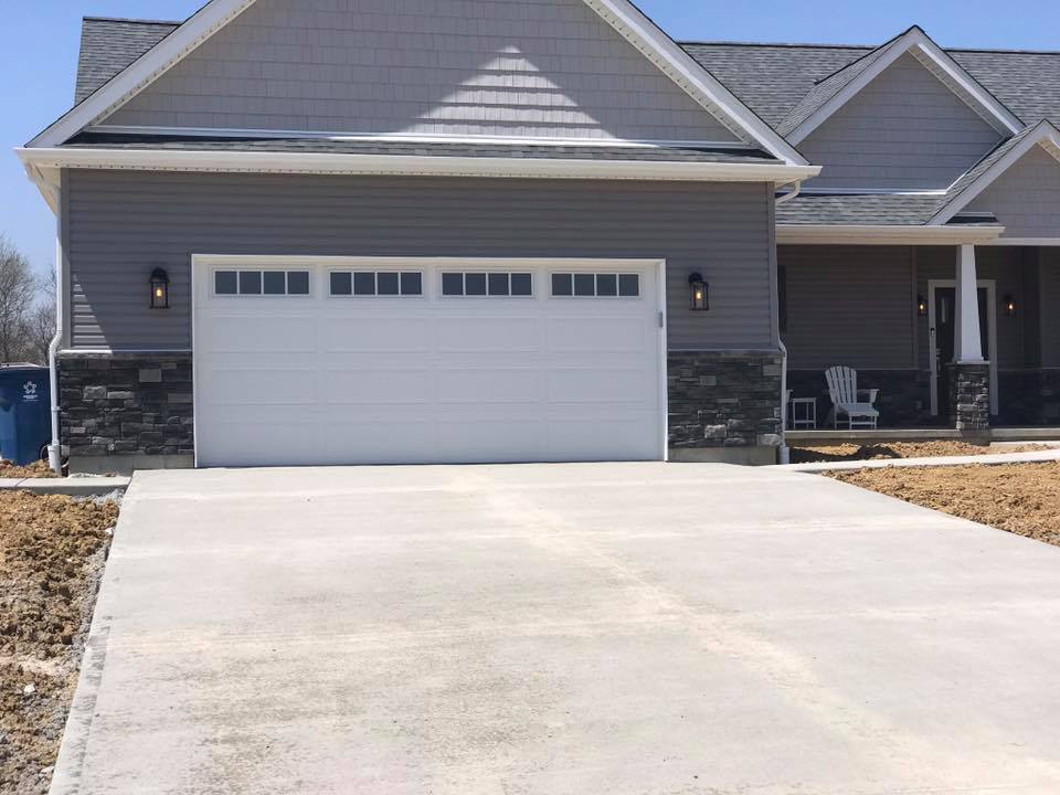 Cape cod house with new double bay garage door installed